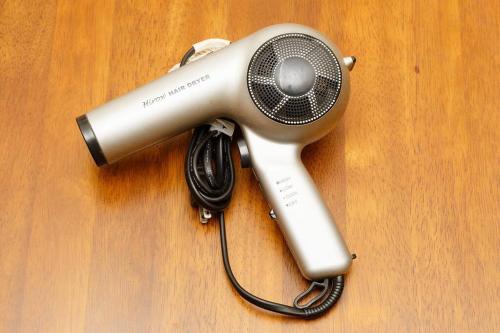 a hair dryer on top of a wooden table at AI/藍 in Kusatsu