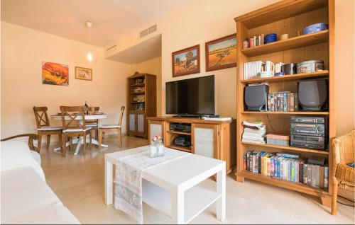 a living room with a couch and a tv and a table at Lovely Apartment In Costa Ballena in Costa Ballena