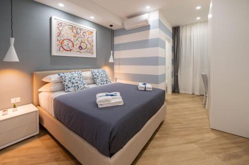 a bedroom with a bed with towels on it at Behome202 in Fisciano