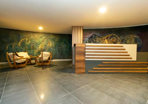 a dining room with a table and a painting on the wall at CONNECT THERMAL HOTEL in Ankara