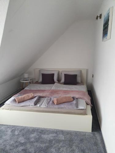 a bed with two pillows on it in a room at Laguna apartman Bogács in Bogács