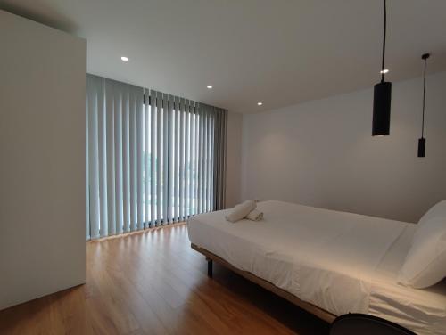 a bedroom with a bed and a large window at VILLA EULALIA in Vinarós