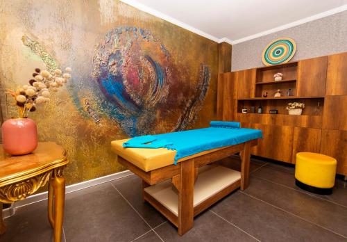 a room with a bench and a painting on the wall at CONNECT THERMAL HOTEL in Ankara