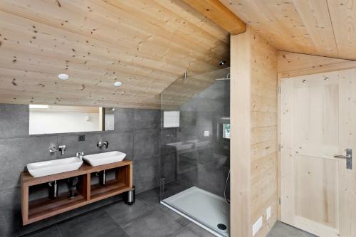 a bathroom with two sinks and a shower at Chalet Haute Cime by Mrs Miggins in Champéry