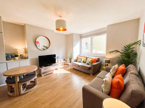 a living room with a couch and a table at Charming Old Town 2 Bed Apt, 2mins from Royal Mile in Edinburgh
