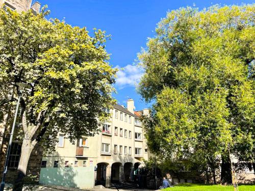 a large building with trees in front of it at Charming Old Town 2 Bed Apt, 2mins from Royal Mile in Edinburgh