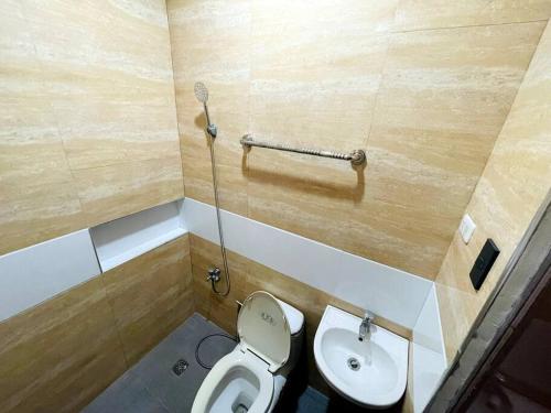 a bathroom with a toilet and a sink at B1 - Spacious 3BR House with Netflix, Fiber Wifi, Parking, Balcony in Cagayan de Oro