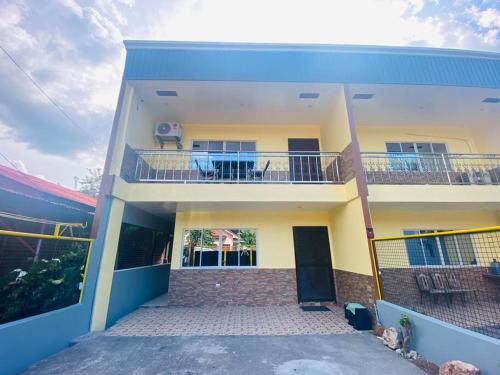 a white and blue house with a balcony at B1 - Spacious 3BR House with Netflix, Fiber Wifi, Parking, Balcony in Cagayan de Oro