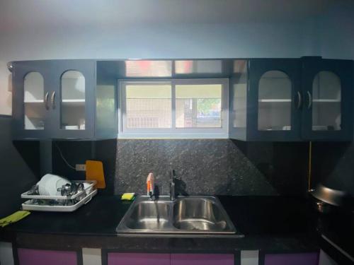 a kitchen with a sink in a toy kitchen at B1 - Spacious 3BR House with Netflix, Fiber Wifi, Parking, Balcony in Cagayan de Oro