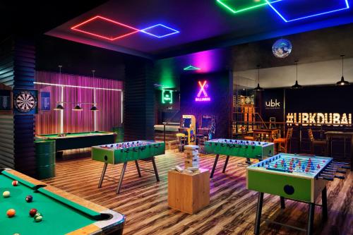 a room with billiards tables and a bar at Mövenpick Hotel Jumeirah Lakes Towers Dubai in Dubai