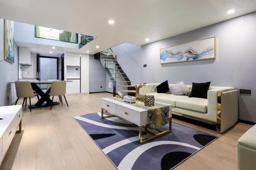 a living room with a couch and a table at Shenzhen Fashion LOFT Apartment in Shenzhen