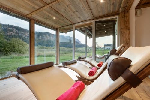 a row of chairs in a room with a large window at Golf- und Sporthotel Moarhof in Walchsee