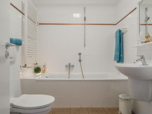 a bathroom with a tub and a toilet and a sink at Ostseeresidenz - Whg 11 in Zingst