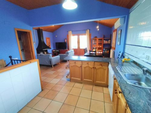 a kitchen with a sink and a living room at EL CAJIGAR ORDESA 6-8 pax in Laspuña