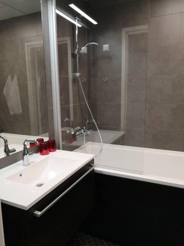a bathroom with a sink and a shower at Centrum Hotel Viljandi in Viljandi
