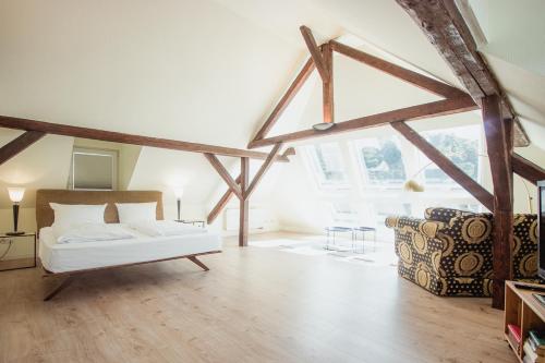 a large room with a bed and a couch in it at Hotel Trabener Hof in Traben-Trarbach