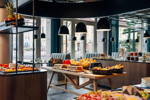 a buffet line with a table of food at Hotel Galántha in Eisenstadt