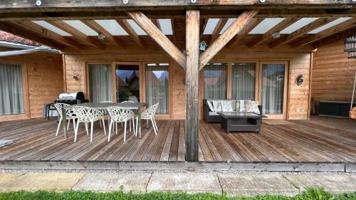 a wooden deck with a table and chairs on it at Mountain Inn Chalets & Apartments in Walchsee