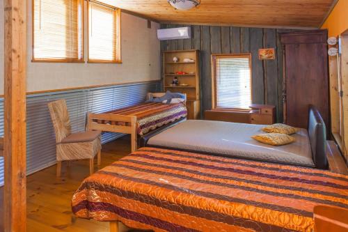 a bedroom with a bed and a table and a desk at Külalismaja Malaika in Põlva