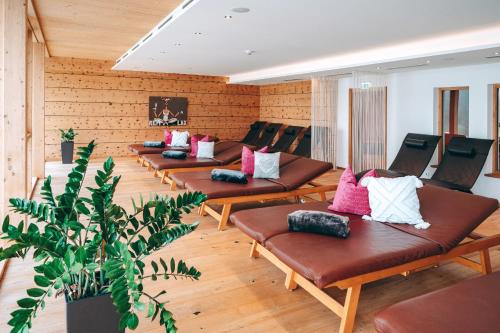 a row of benches with pillows in a room at Familienresort Buchau in Maurach