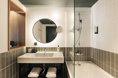 a bathroom with a sink and a shower at Hotel Galántha in Eisenstadt