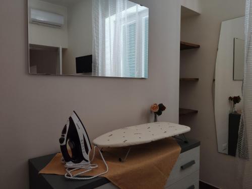 um quarto com uma cadeira e um espelho numa secretária em Gregorius Diamerisma panoramic terrace em Nápoles