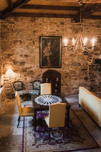 a dining room with a table and chairs at Pazo de Eidian in Eidián