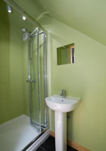 a bathroom with a sink and a shower at Tarset Tor - Bothy 3 in Greenhaugh