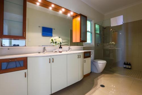 a bathroom with a sink and a toilet at Beautiful Home with Breath-taking Views Mt Tamborine in Eagle Heights