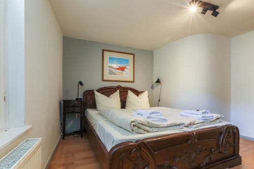 a bedroom with a large bed with white sheets at Apartments im Einhornhaus in Lübeck