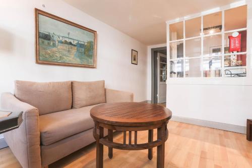 a living room with a couch and a table at Apartments im Einhornhaus in Lübeck
