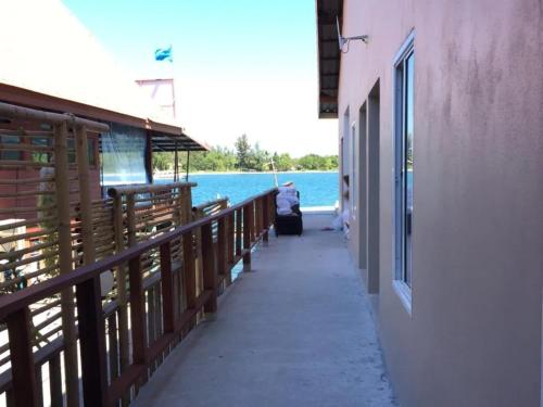 a walkway next to a building next to the water at Non Du Lay Guesthouse in Ko Lanta
