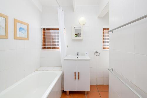 a white bathroom with a tub and a sink at San Lameer Villa 2408 - 2 Bedroom Classic - 4 pax - San Lameer Rental Agency in Southbroom