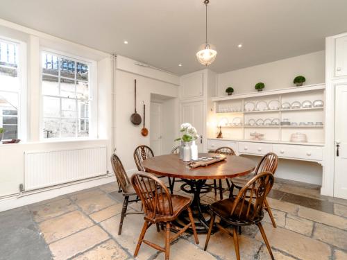 a dining room with a wooden table and chairs at Pass the Keys Elegant Georgian Townhouse in the heart Bath in Bath