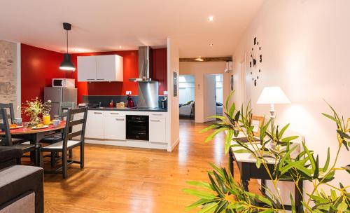 une cuisine et un salon avec une table et des chaises dans l'établissement Les Gîtes du château - L Appartement du Roi - Magnifique Appartement face au château, à Nérac