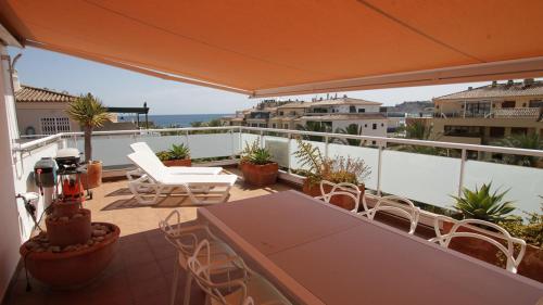 a patio with a table and chairs on a balcony at Penthouse La Paz 9 - Castle view in Moraira