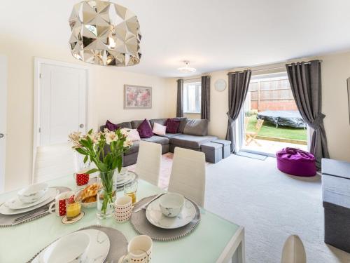 a living room with a table and a couch at Pass the Keys Stylish modern two bedroom home in Shrewsbury in Shrewsbury