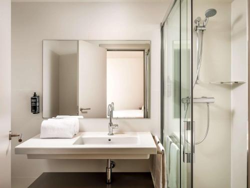 bagno bianco con lavandino e doccia di ibis Styles Barcelona Centre a Barcellona