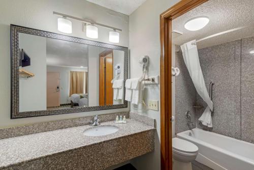 a bathroom with a sink and a toilet and a mirror at Quality Inn Acworth in Acworth