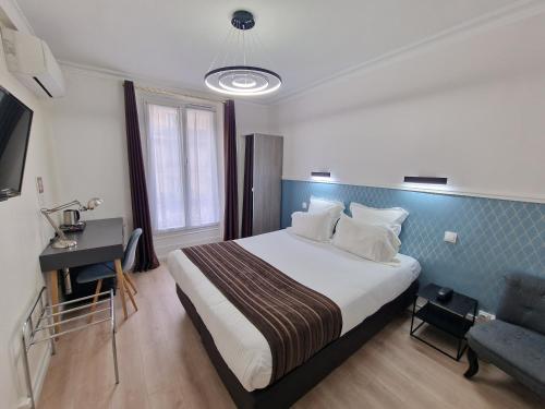 Ένα ή περισσότερα κρεβάτια σε δωμάτιο στο Hôtel Océanic - Grands Magasins