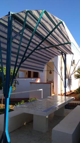 a picnic table with awning on a patio at Villa San Vito Bay in Macari