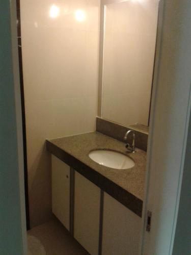 a bathroom with a sink and a mirror at Studio 230 Eco Paradise Cumbuco in Cumbuco