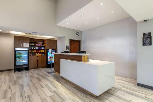 a lobby with a counter and a refrigerator at Comfort Inn & Suites in Muskogee