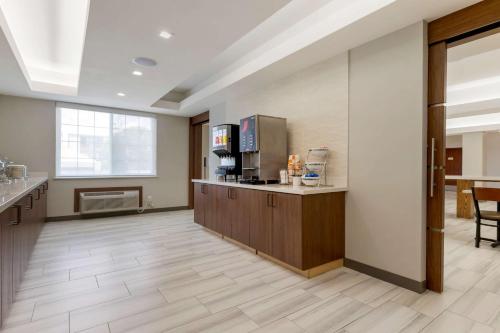 a large room with a lobby with a coffee shop at Comfort Inn & Suites in Muskogee