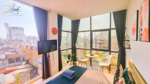 a bedroom with a bed and a large window at Libré Homestay in Hanoi