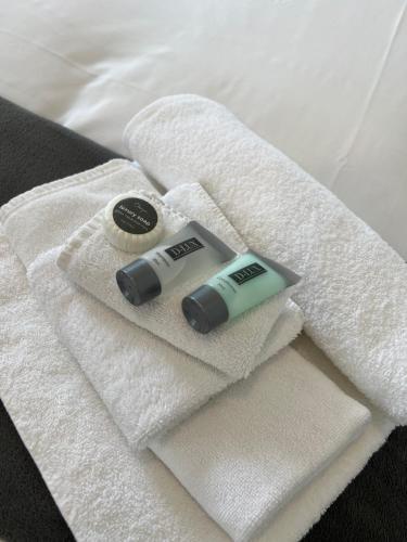 a couple of towels and a tube of toothpaste on a bed at Hotel Concord in Sydney