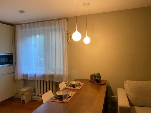a dining room with a table and a window at Studio apartment Ogre in Ogre