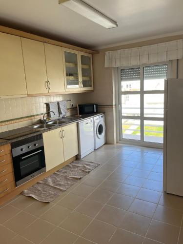 a kitchen with a sink and a dishwasher at Tome's House - Baleal Solvillage 2 in Ferrel