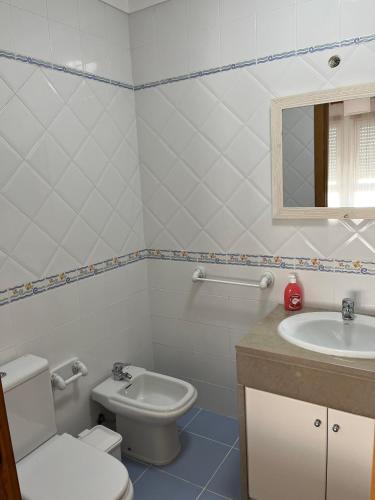 a bathroom with a toilet and a sink at Tome's House - Baleal Solvillage 2 in Ferrel