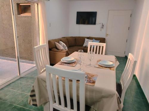 mesa de comedor con sillas y sofá en Céntrico y moderno departamento en San Rafael
